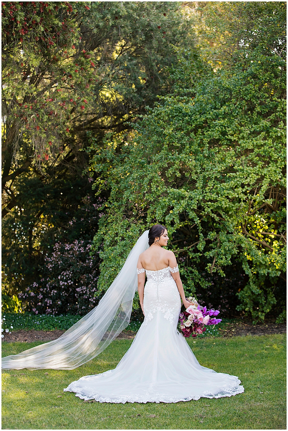 Bride posing showing the back of dress