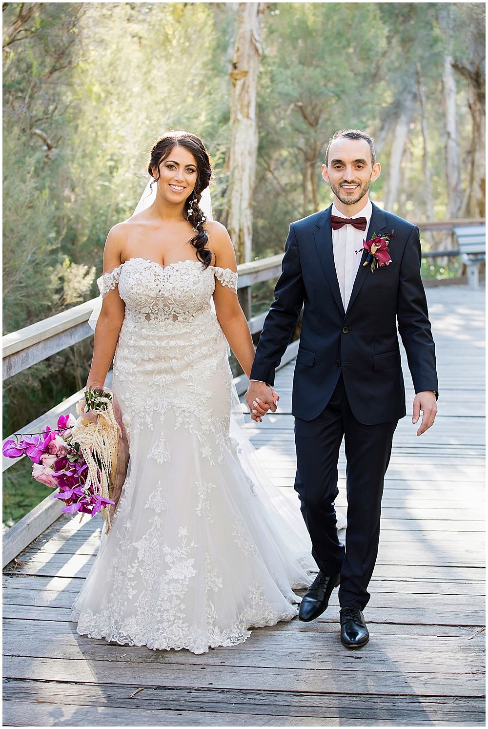 Bride and groom walking down boardwalk in South Perth