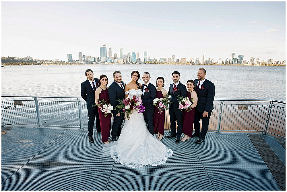 Bridal party standing on viewing platform with Perth in the background.