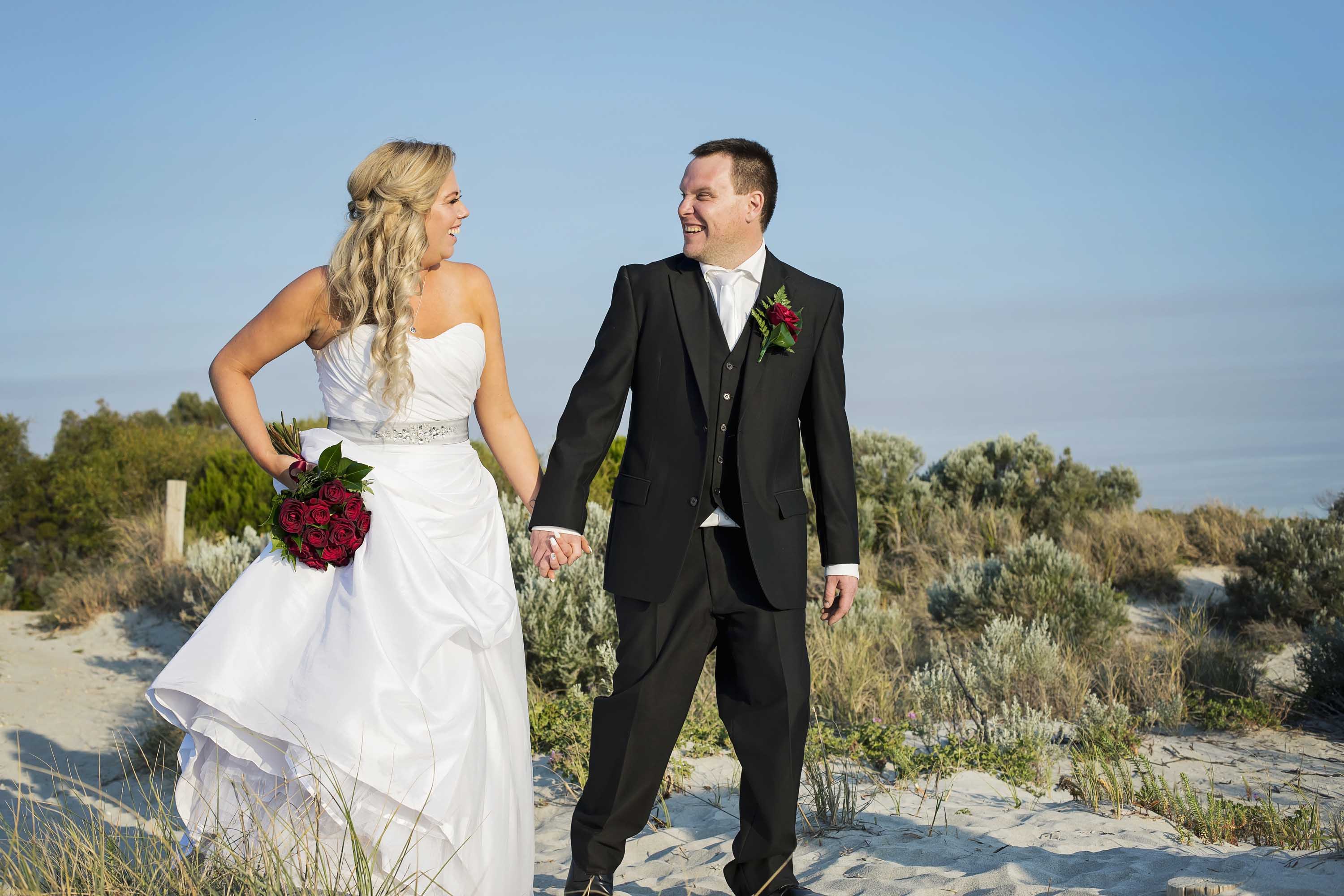 Bride and groom outside Coogee beach life saving club