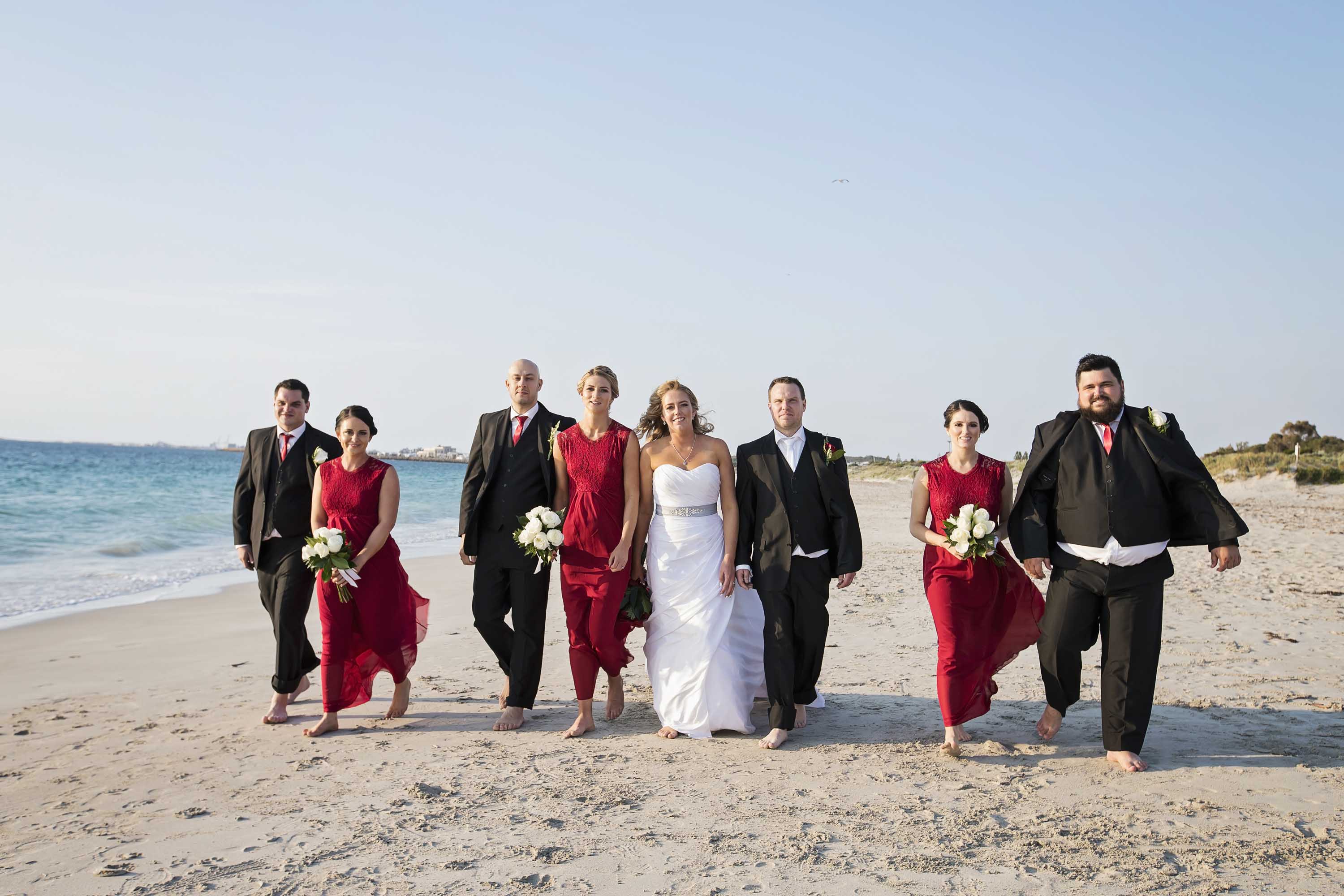 Bridal party on beach outside Coogee beach life saving club