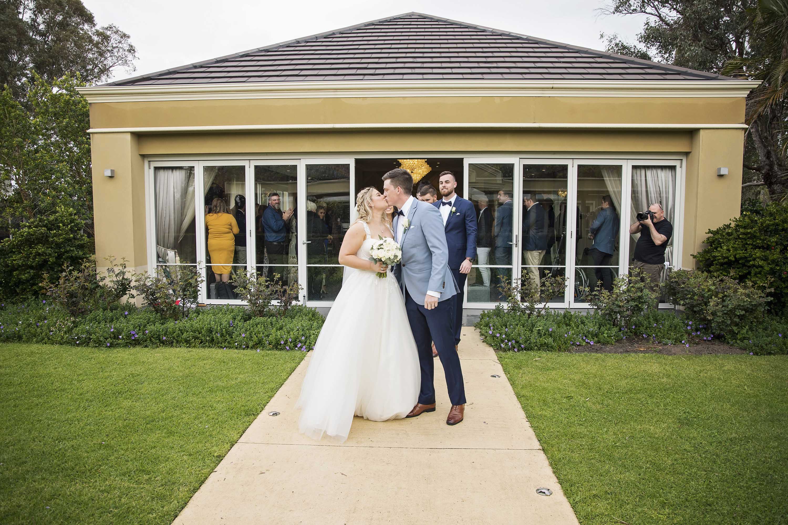 Bride and groom kiss outside Garden House at Caversham House, Swan Valley